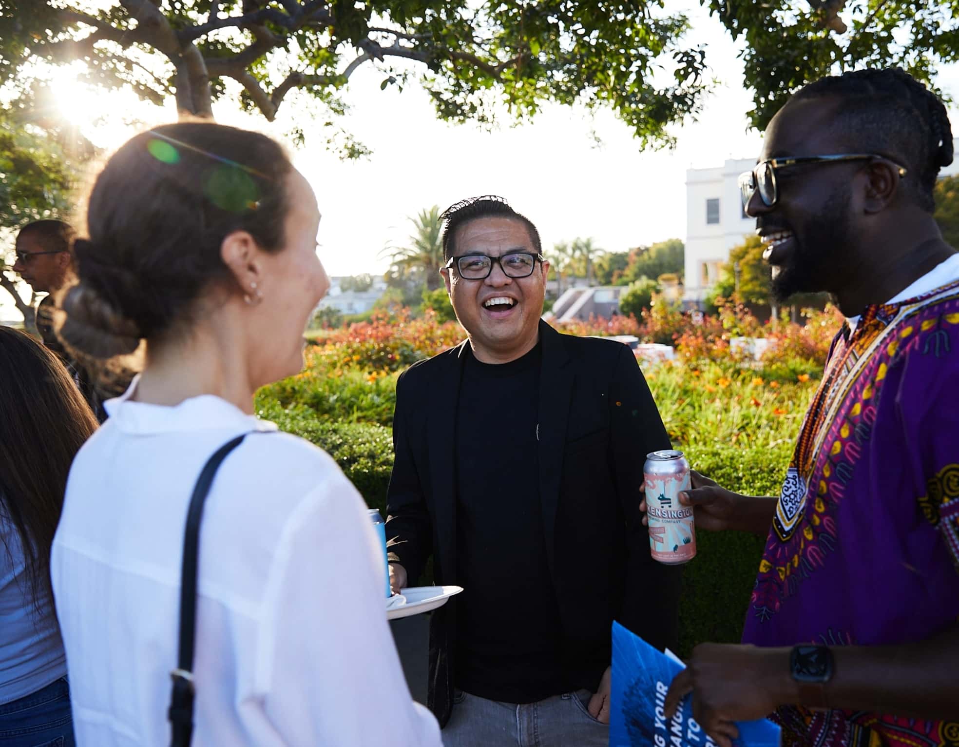 three people laughing on the university of san diego campus-min