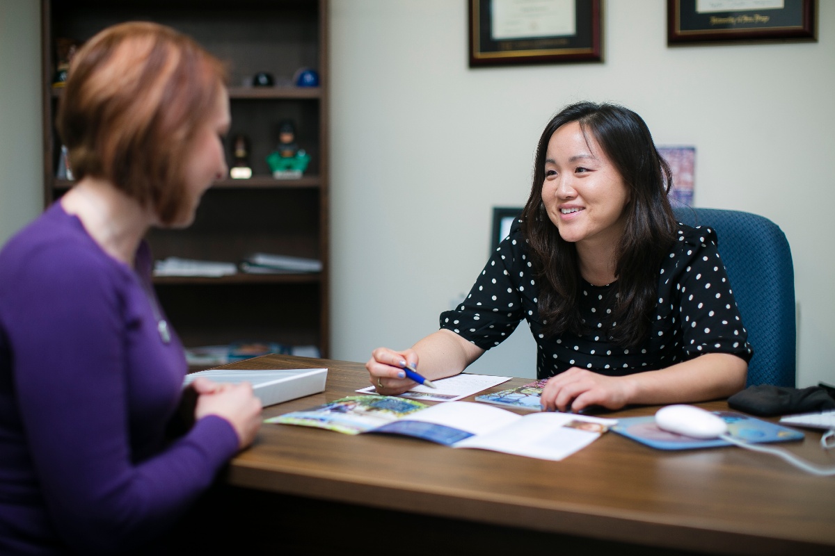 higher education professional meeting with student